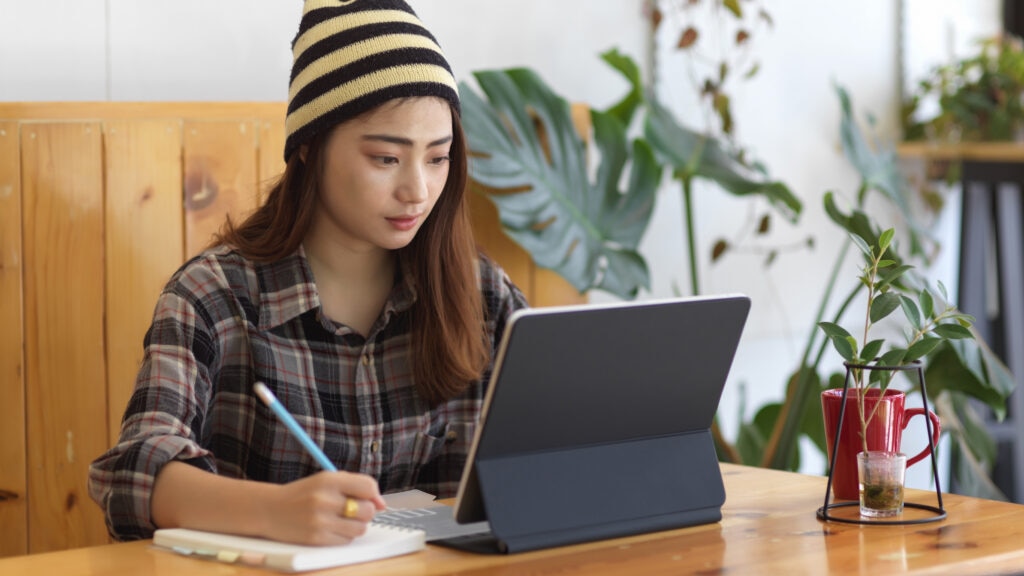 cover letter examples for retail positions A young woman working on her tablet in a cafe.