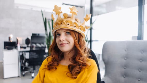 Woman sitting on the office wearing a crown