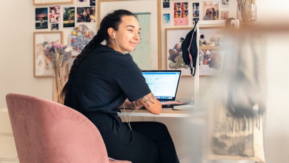 Young woman working on computer in her home office.