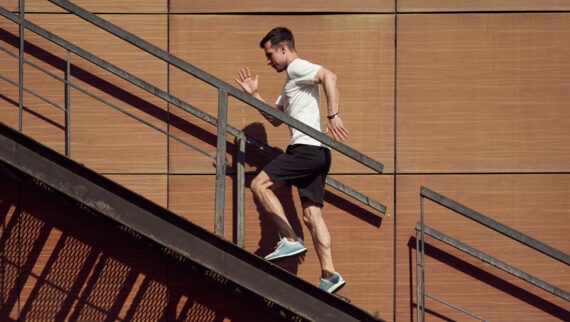 Man running up a metallic stair