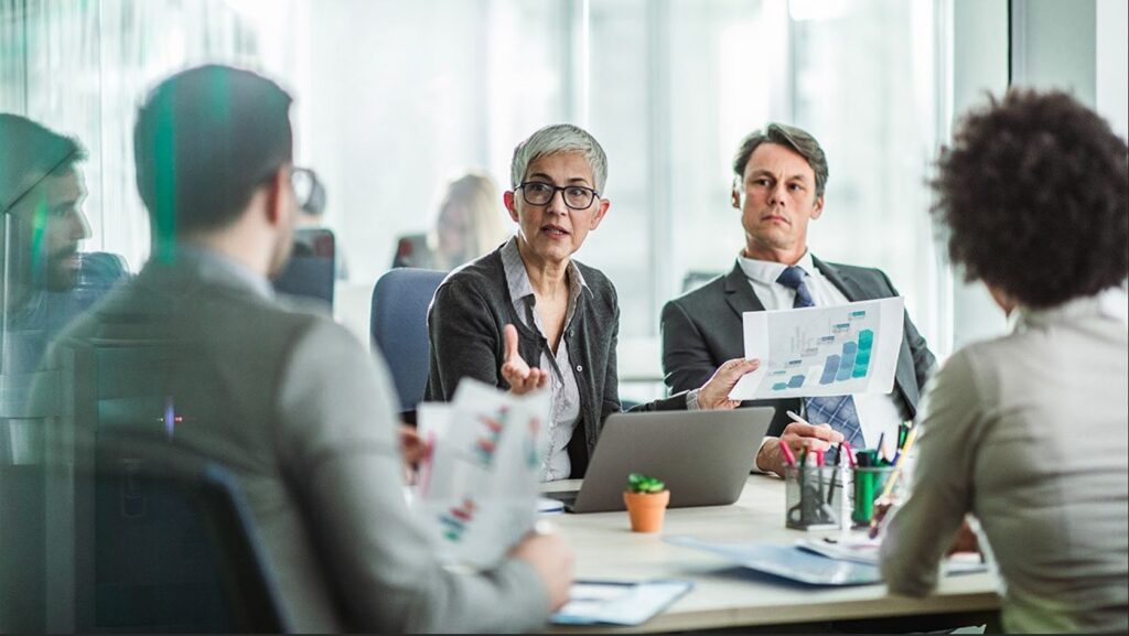 Colleagues in a meeting discussing their compensation strategy