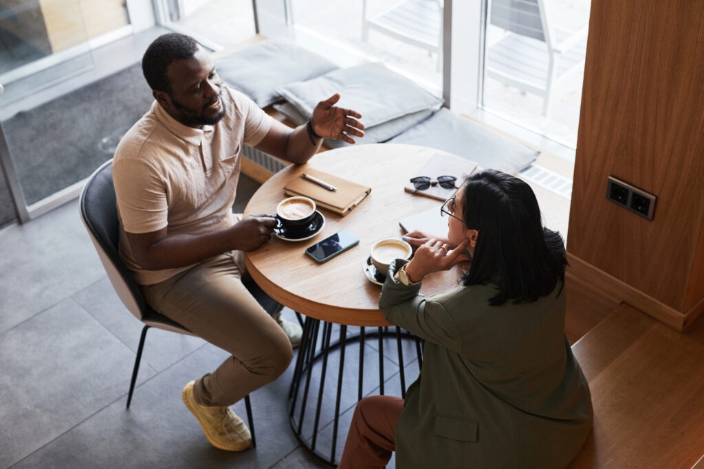 Two colleagues discussing fertility policy at work