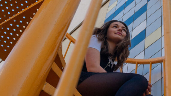 young woman sitting on stairs