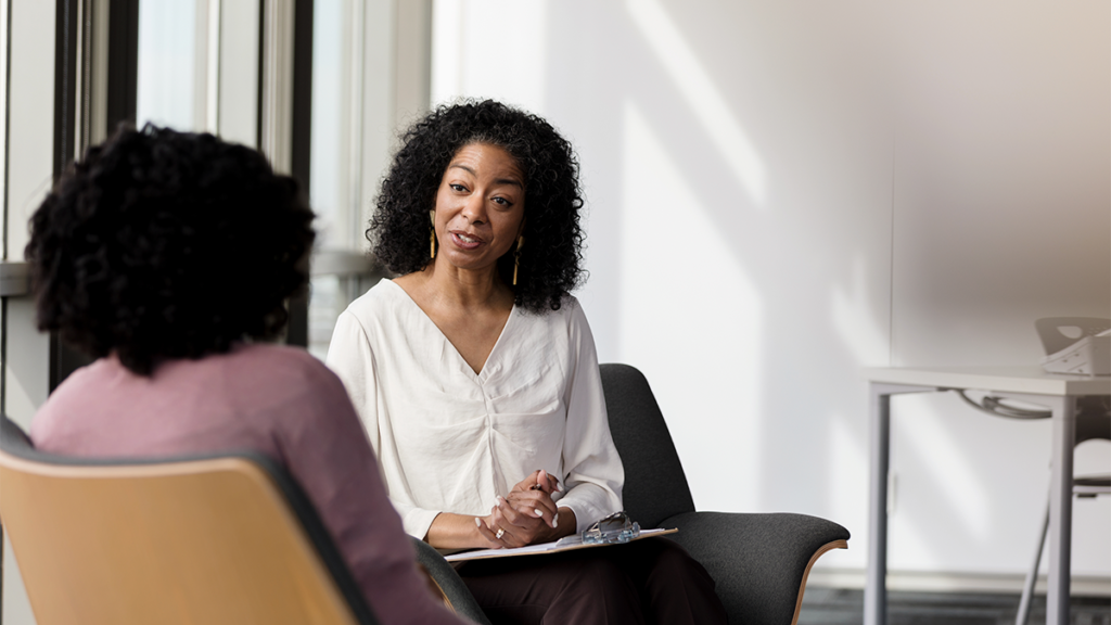 A manager conducting a return to work interview with an employee