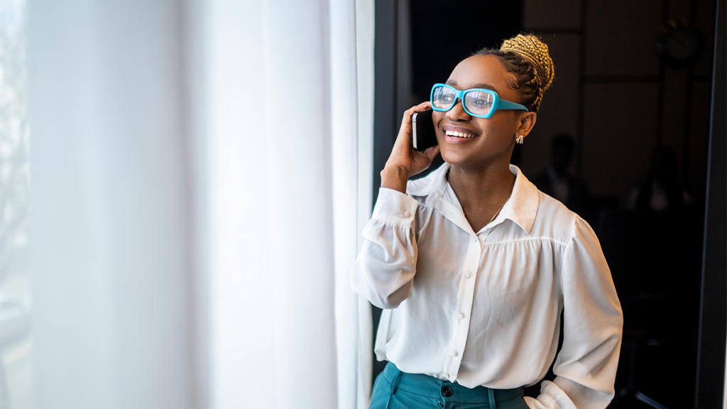A woman on the phone in the office.