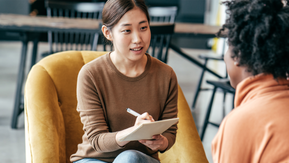 An employee making notes during an interview