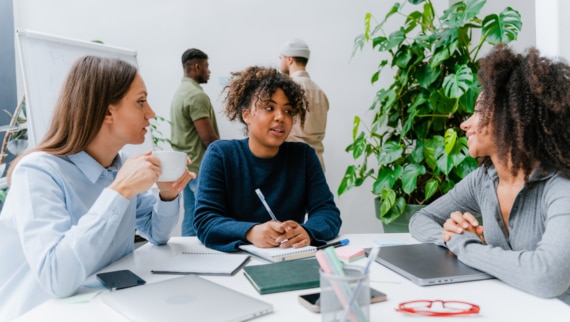 A diverse group of colleagues having a meeting in a modern office environment