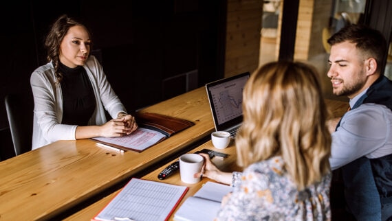 Man and woman conducting a business interview in a board room