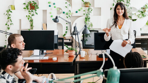 A employee presenting to three co-workers