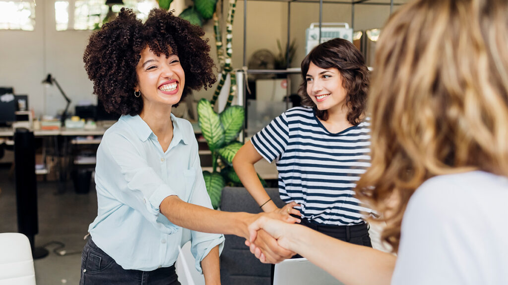 Interviewers greeting a candidate at the beginning of a competency-based interview