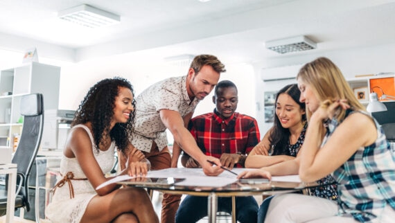 A group of people discussing in an office