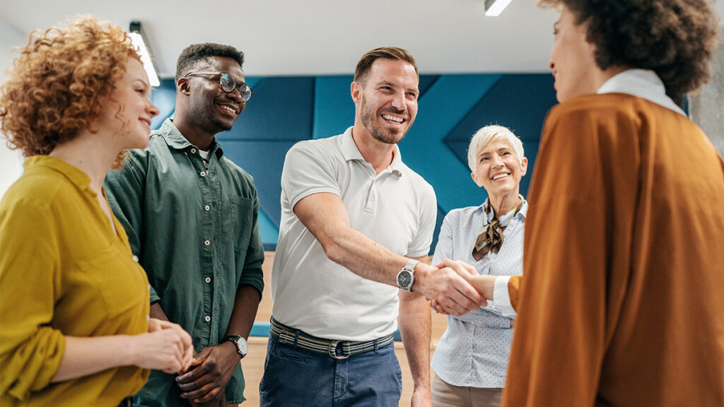 A new starter greeting their colleagues following a successful referral scheme