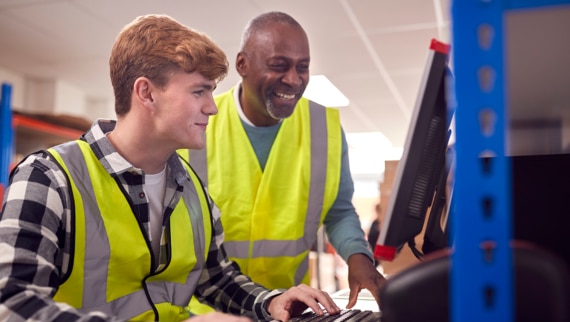 Colleagues working on a computer during their returnship