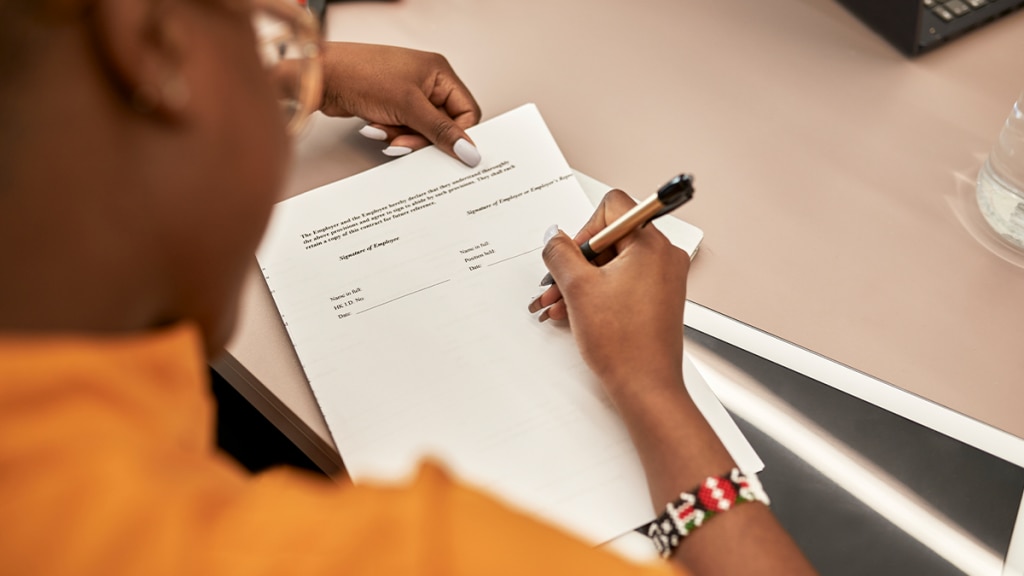 A worker reviewing their contract of employment