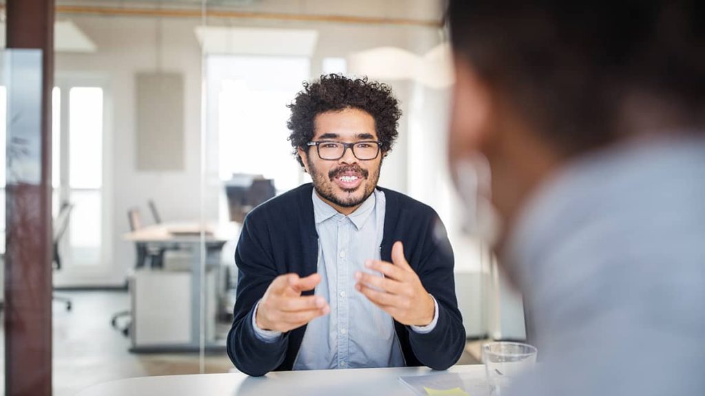 A manager conducting an exit interview with a departing employee in the office