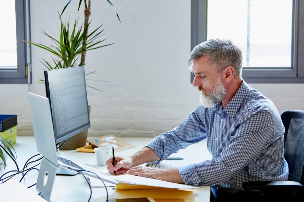A business leader working in the office to calculate employee retention rate