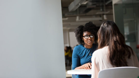 An image of a recruiter giving feedback to an interview candidate.