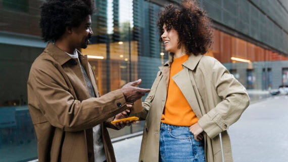 Two colleagues having a discussion outside