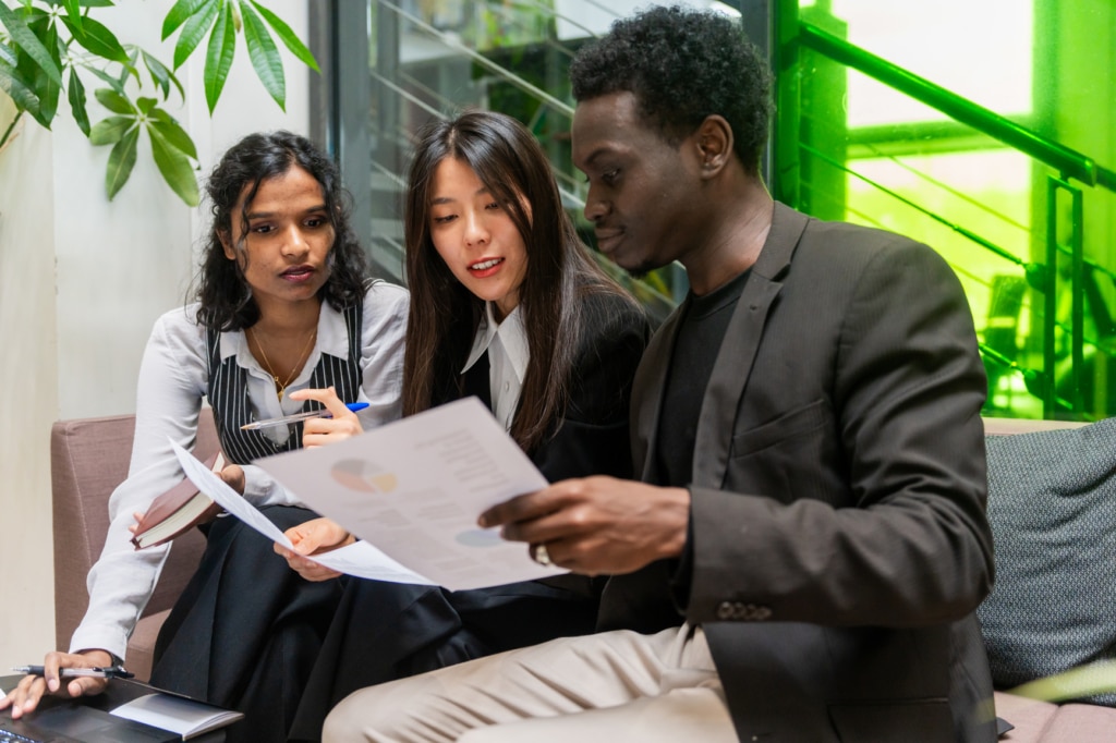 A team of recruiters analysing data in an office setting