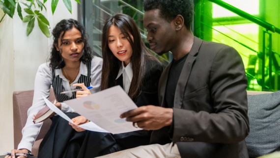 A team of recruiters analysing data in an office setting