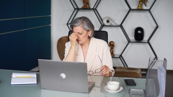 A senior manager struggling to deal with staff absences in a modern office space