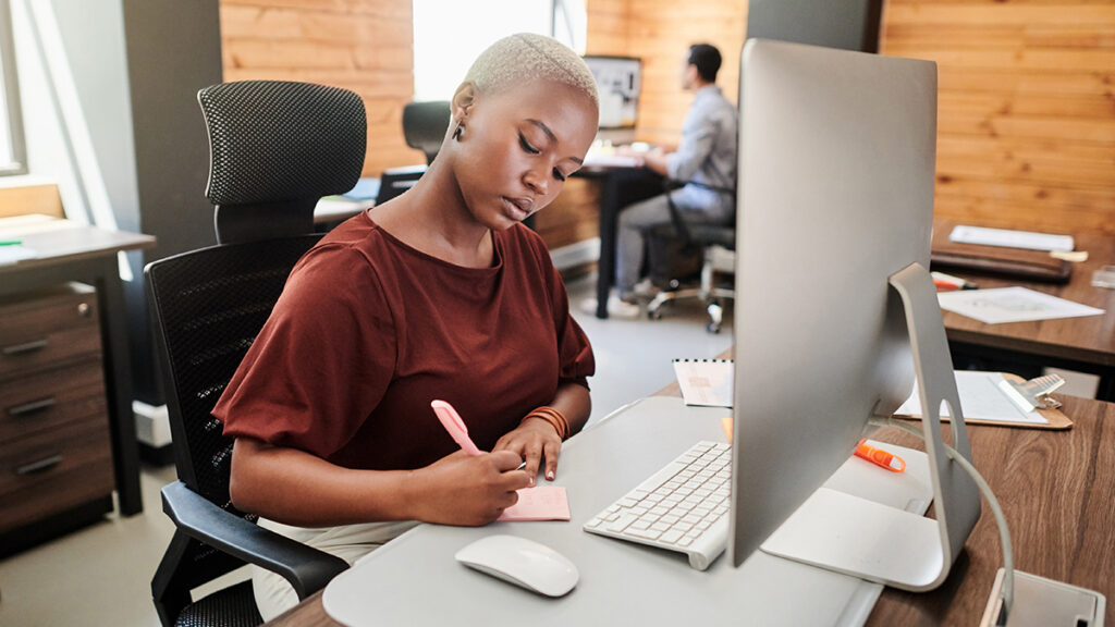 A hiring manager making notes before writing a job ad for a vacancy