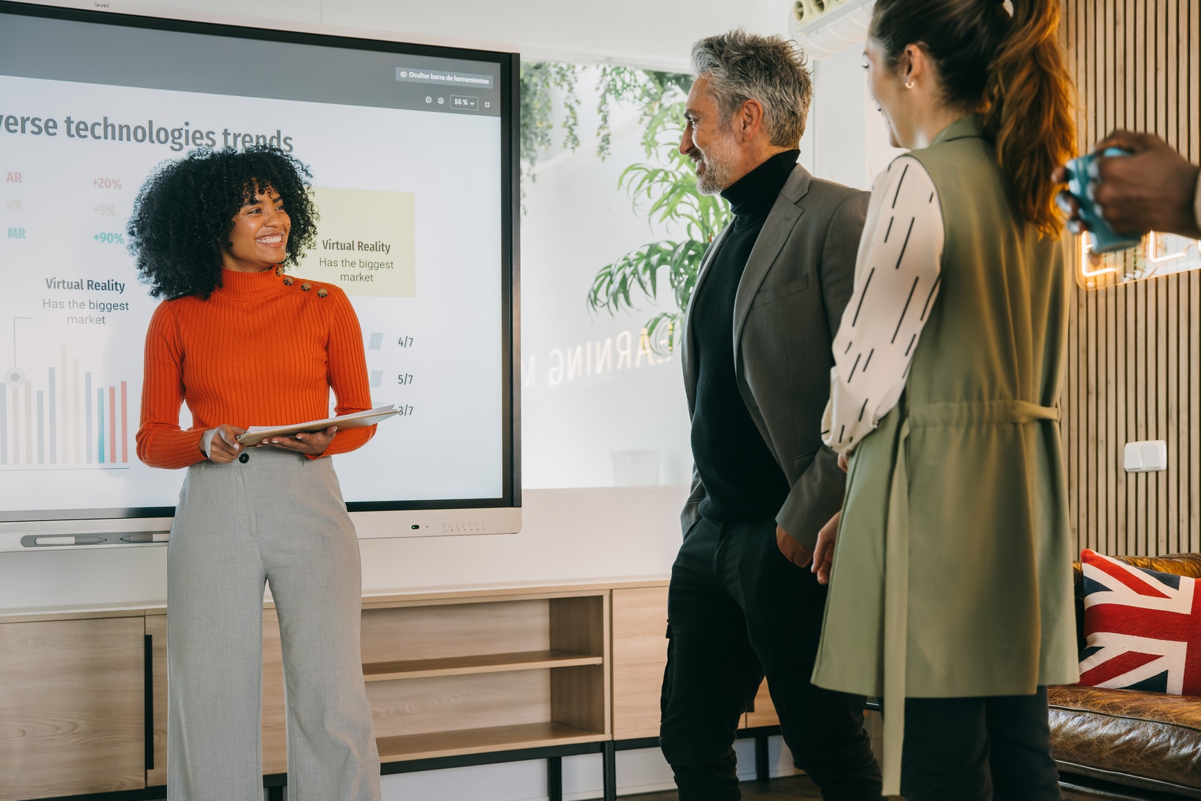 Business professionals collaboratively discussing recruiting trends in a modern office setting, with a focus on the developments of the market