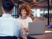 Woman interviewing man in office