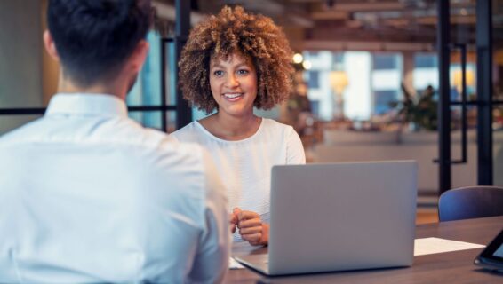 Woman interviewing man in office