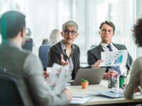 Colleagues in a meeting discussing their compensation strategy