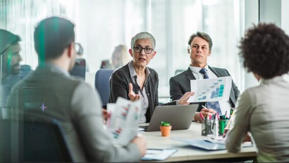 Colleagues in a meeting discussing their compensation strategy