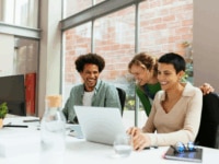 A group of happy and engaged workers in the office, highlighting the effectiveness of employee retention strategies