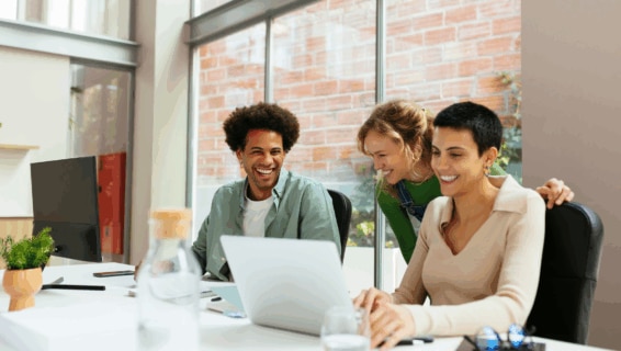 A group of happy and engaged workers in the office, highlighting the effectiveness of employee retention strategies