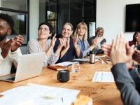Happy employees applauding in a meeting room