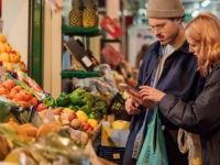 Two people buying food at a market