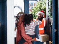 A seasonal worker delivering a parcel