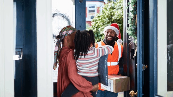 A seasonal worker delivering a parcel