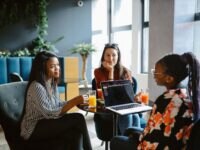 Group of female colleagues having a meeting over breakfast