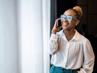 A woman on the phone in the office.