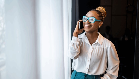 A woman on the phone in the office.