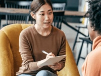 An interviewer taking notes during an interview