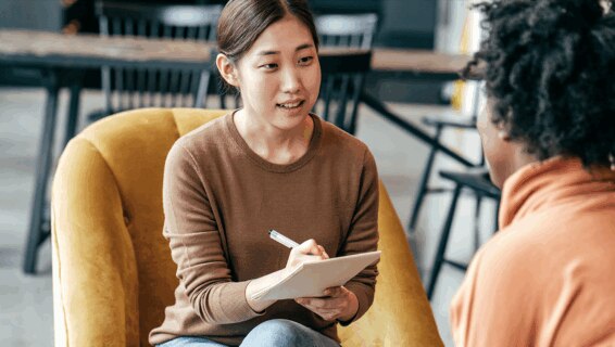 An interviewer taking notes during an interview