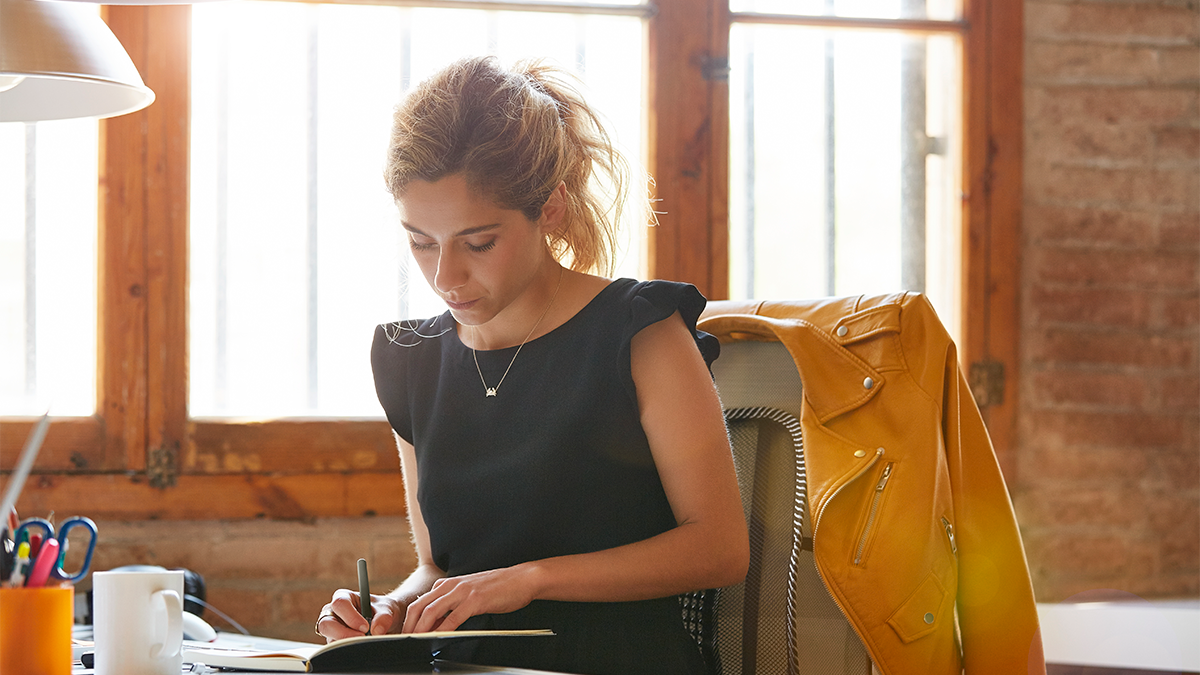 A woman writing the job description for a new role