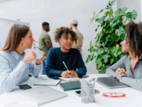 A diverse group of colleagues having a meeting in a modern office environment