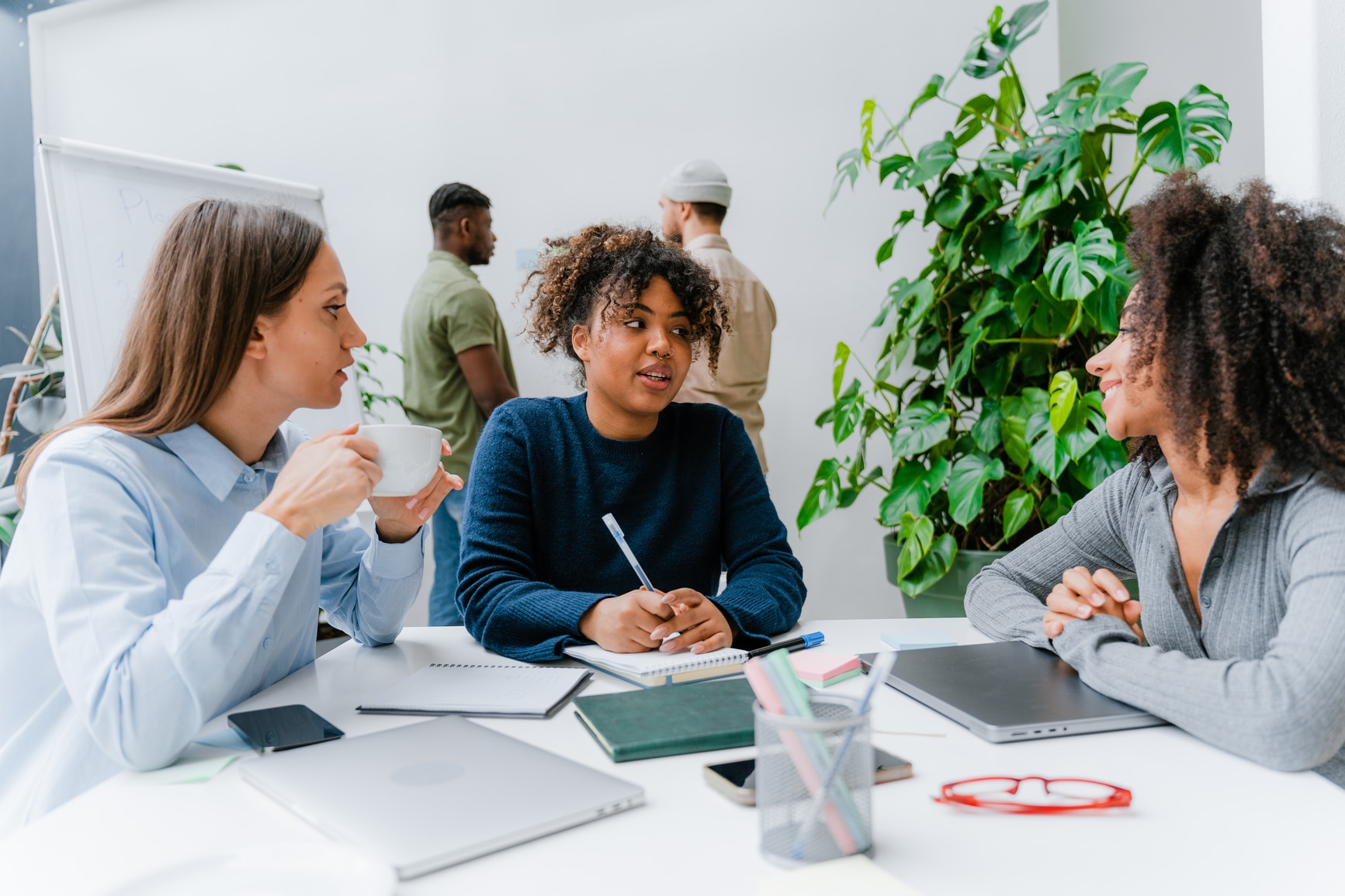 A diverse group of colleagues having a meeting in a modern office environment