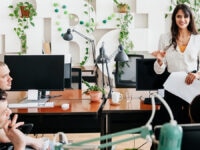 A employee presenting to three co-workers