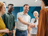 A new starter greeting their colleagues following a successful referral scheme