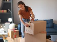 An employee packing up their belongings in their home in preparation for relocating for work