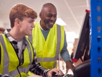 Colleagues working on a computer during their returnship