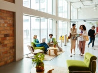 Busy businesswomen discussing together while walking in modern office